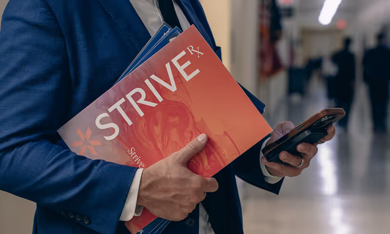 businessman-suit-folder-phone-strive-nav-telehealth